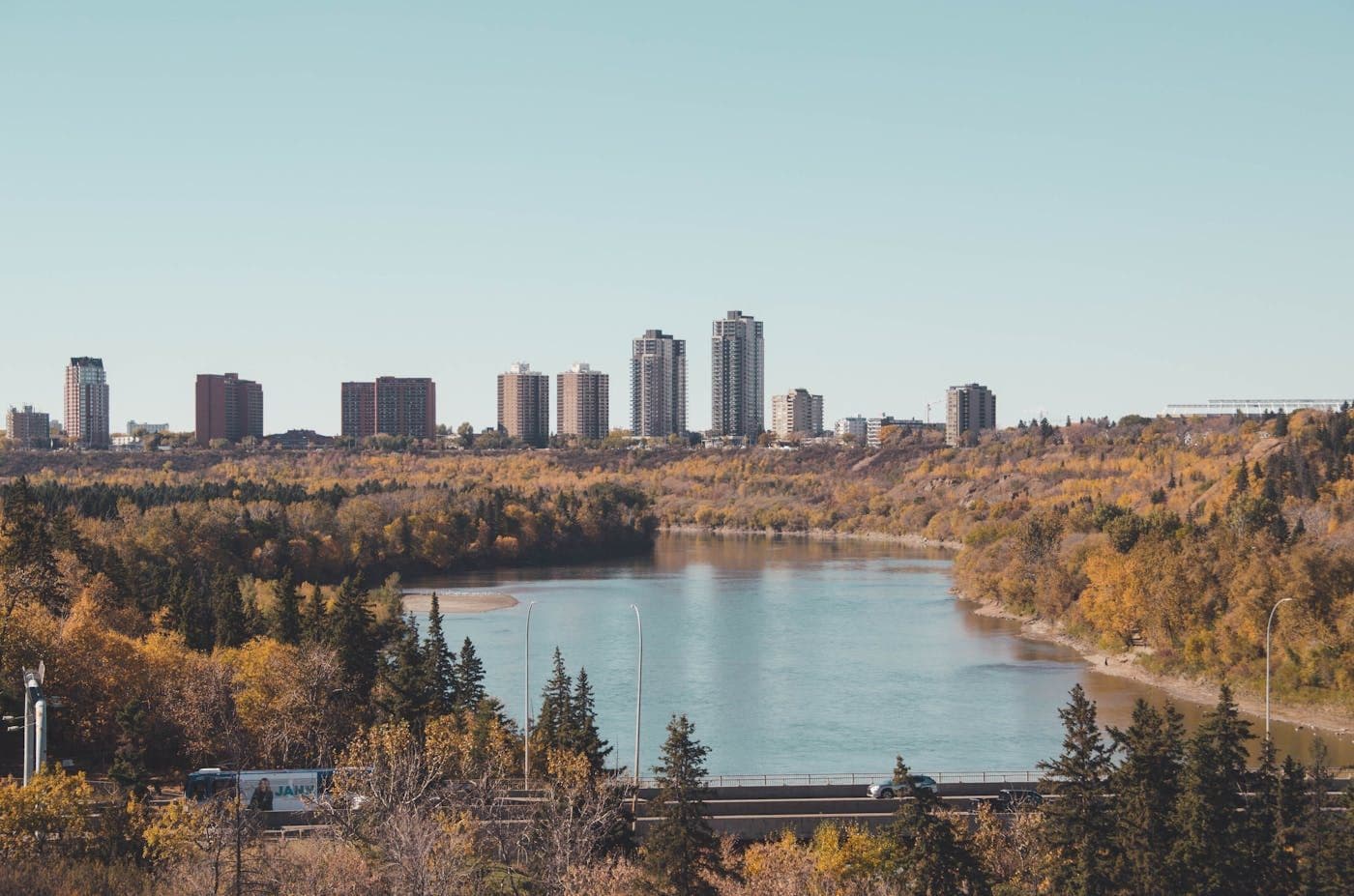 Edmonton's downtown skyline above the North Saskatchewan River valley in autumn, the city Longhand calls home.