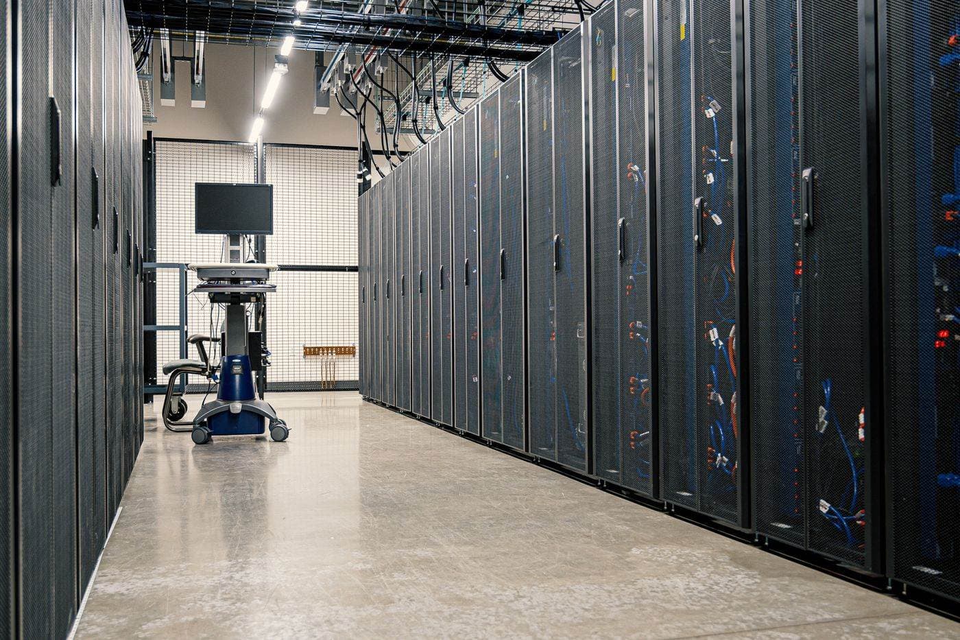 An aisle of server racks in a data centre — the kind of infrastructure behind AI and data-platform work.